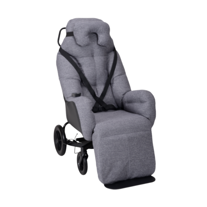 Manual wheeled frame shell seat designed for dependent users, featuring a 30-degree recline, manual leg rest, and visco cushion for added comfort. Practical for indoor and outdoor use with a secure foot brake system.