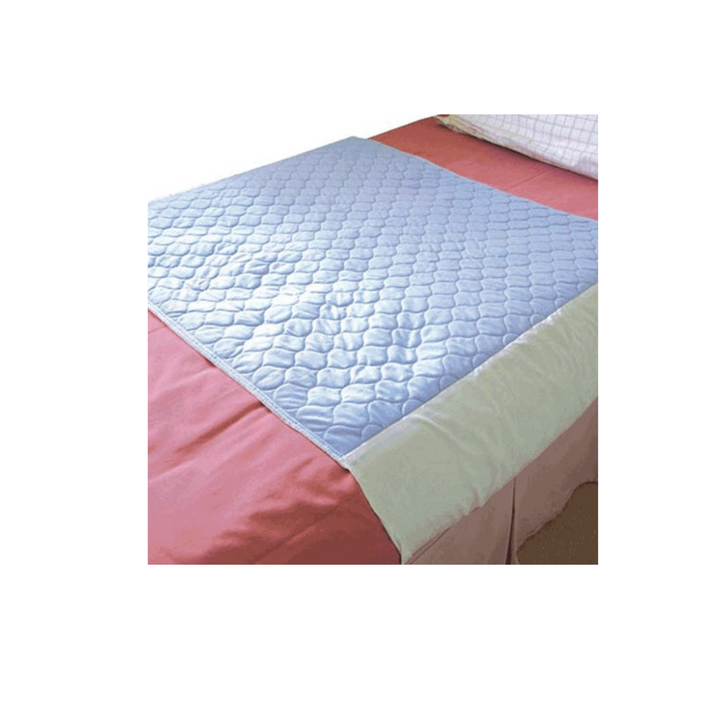 a blue bed pad with tuck ins on a bed