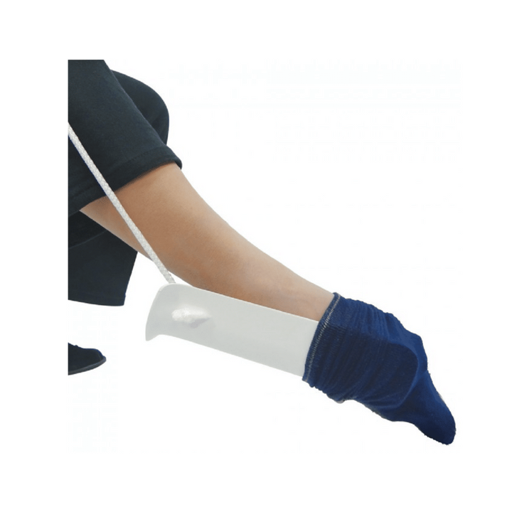 The sock notch cord style sock aid has a unique notch cut out at the lower end which hooks the sock. The attached tapes/cord is used to pull the sock aid over the patients feet.

