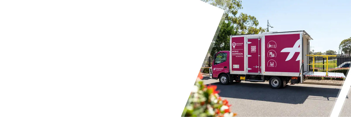 A magenta delivery truck with white graphics and a prominent logo on its side.